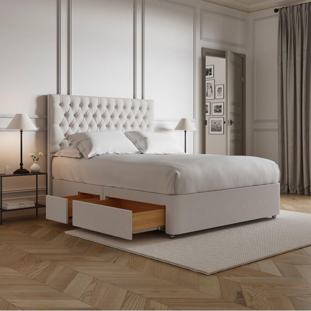 a bed with a white headboard and drawers underneath