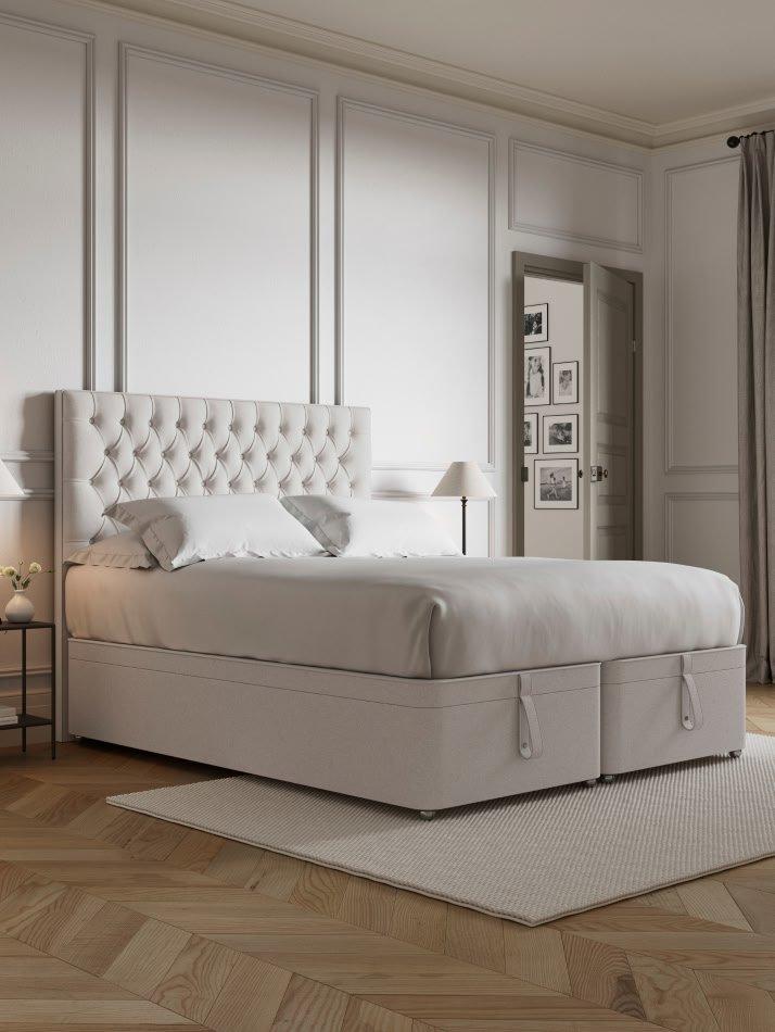 a large bed with a white headboard and footboard in a bedroom