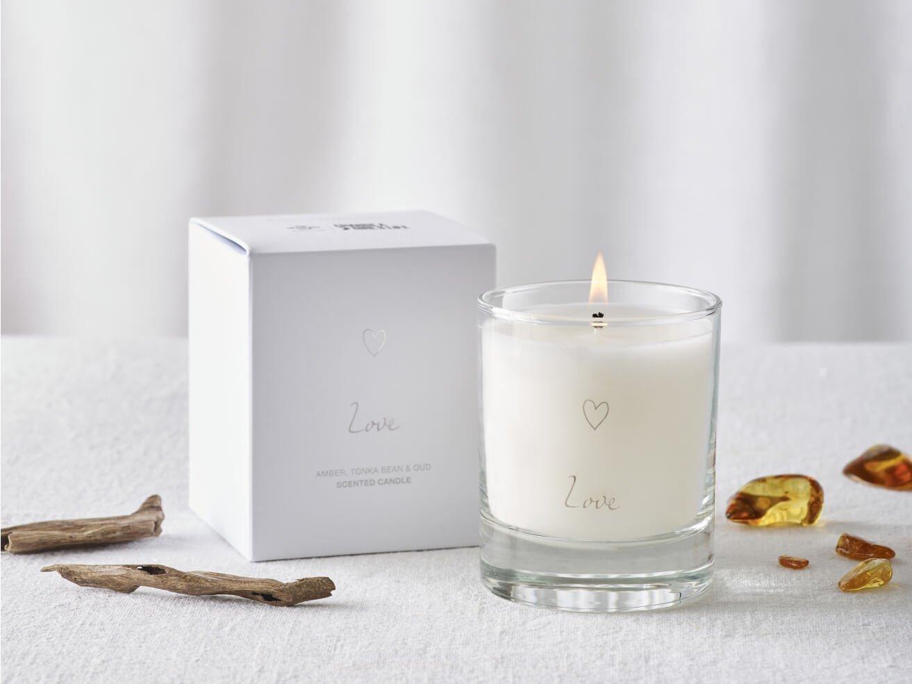a candle next to a box with some rocks and a note