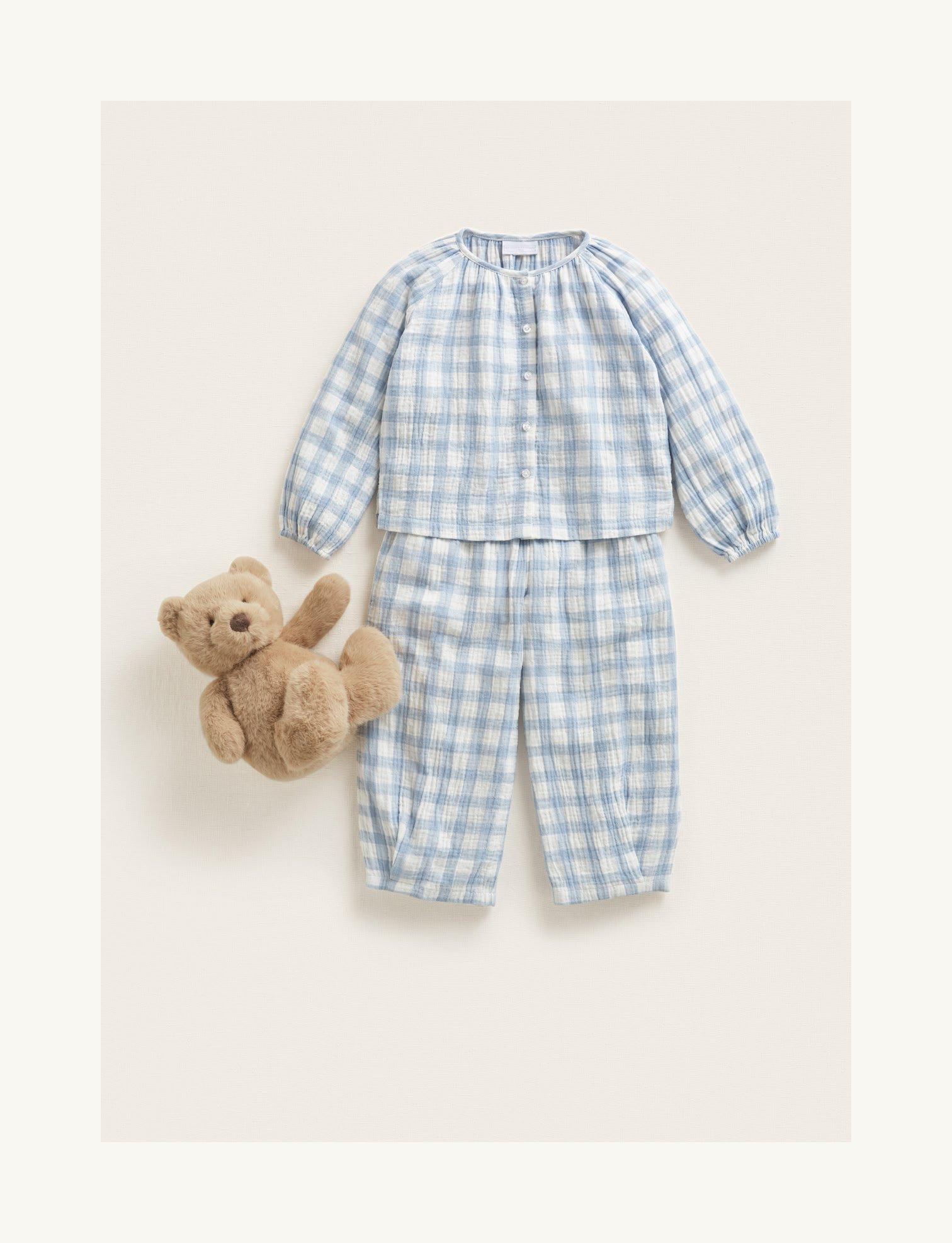 a baby's pajamas and a teddy bear are shown