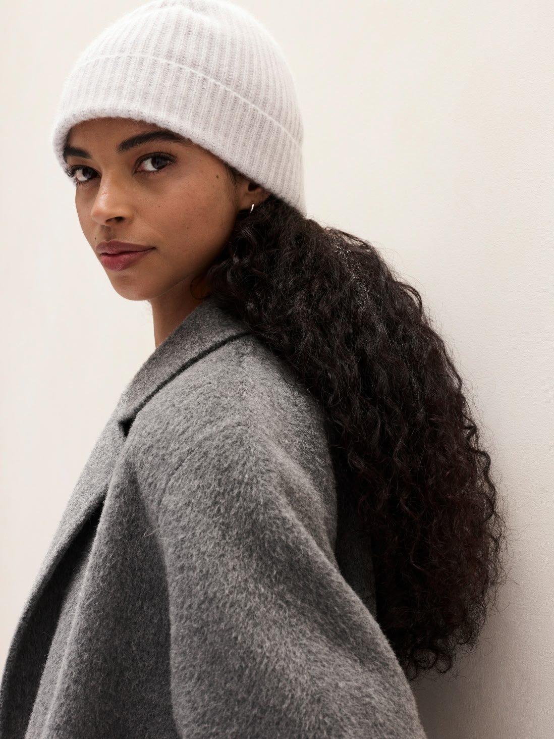 woman in a grey coat and ribbed hat