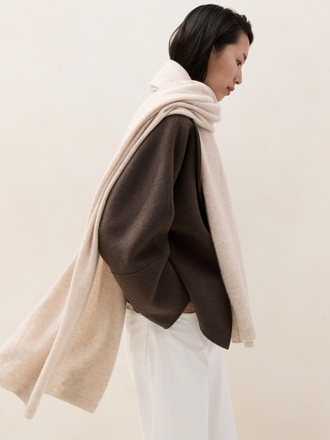 woman in a brown jumper and cream scarf
