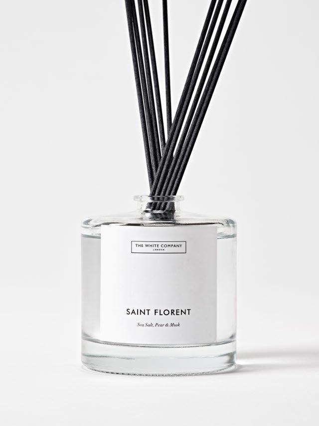 a glass bottle with reed diffusers in it