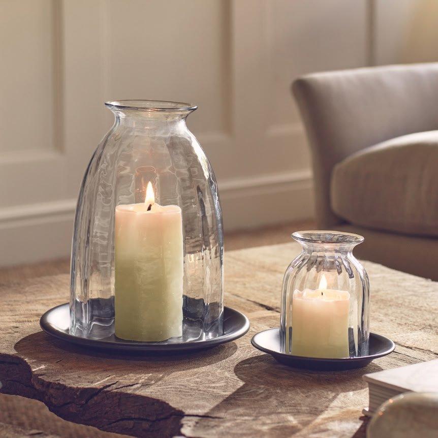 a couple of candles sitting on a table next to each other