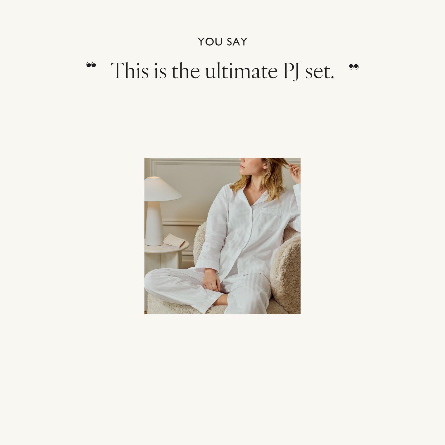 a woman is sitting on a couch with a white pajama top