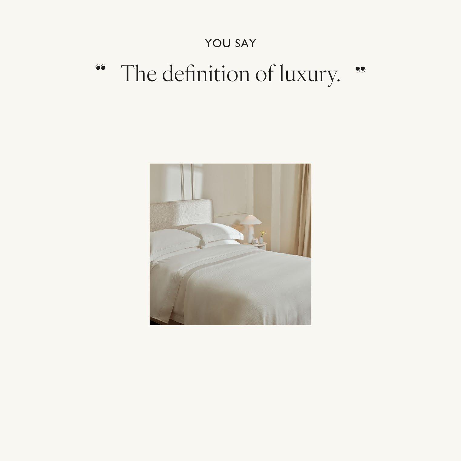 a bed with a white sheet and a white pillow on it