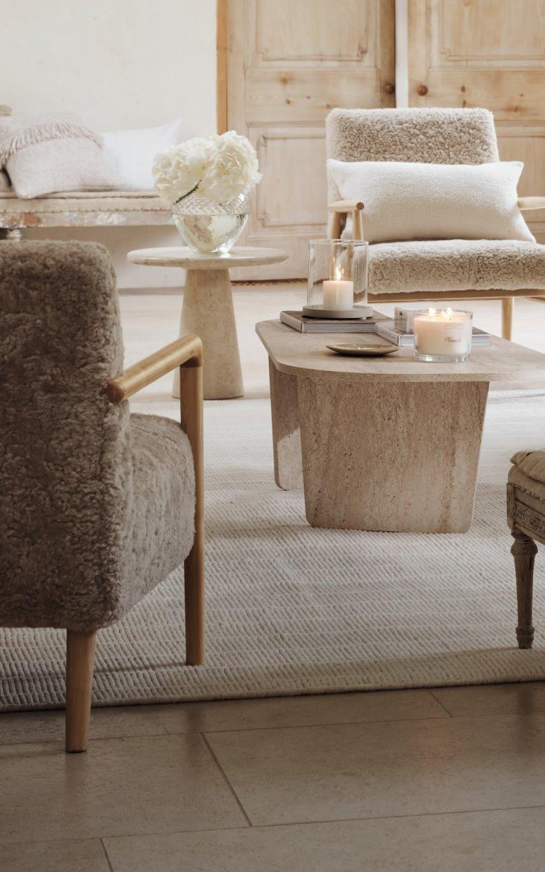 a living room with a couch, chair, table and a lamp